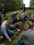 Students examining a sediment core extracted with a Russian corer