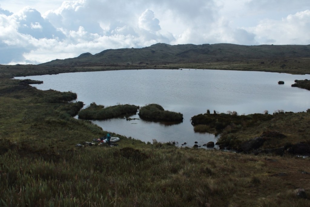 Condorcillo in a rare moment of sunlight. One of our inflatable boats, used to construct the rig for coring, is pictured on the shore. Photo credit: Rachel Sales