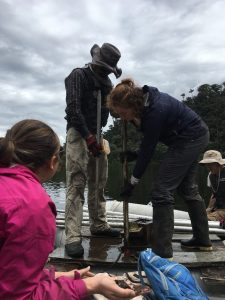 Rachel Sales, Bryan Valencia, and Majoi de Novaes Nascimento coring a different lake. In this picture, we have just pulled a core of mud up from the bottom of the lake. Photo credit: Seringe Huisman